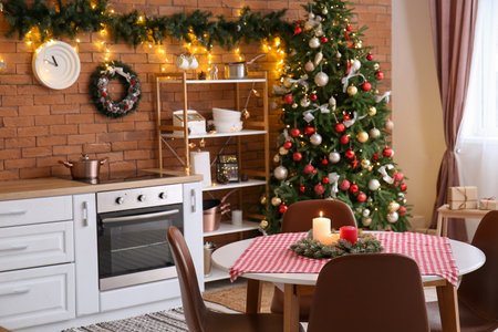 Dining table with Christmas wreath and candles in the kitchenの写真素材