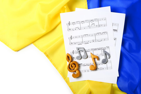 Sheet music with notes and Ukrainian flag on white backgroundの写真素材