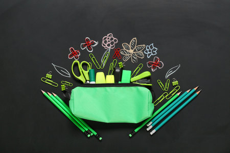 Composition with different stationery on dark background