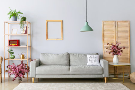 Interior of living room with vases and blossoming branchesの写真素材
