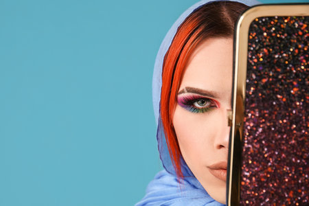 Stylish transgender woman on blue background, closeupの写真素材