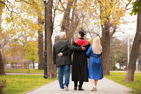 Young man with his parents on graduation dayの写真素材