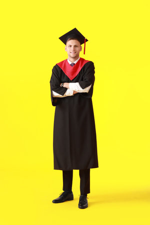 Male graduating student on color backgroundの写真素材