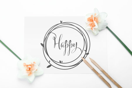 Paper with word HAPPY, dip pens and flowers on white backgroundの写真素材
