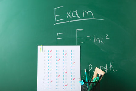 Answer sheet and stationery on blackboardの写真素材