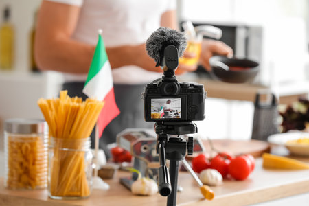 Cooking Italian chef on display of photo camera in kitchenの写真素材