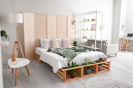 Interior of stylish bedroom with folding screenの写真素材