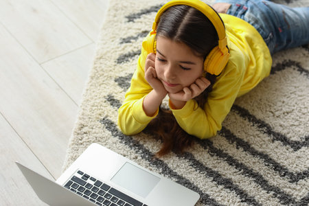 Cute girl watching cartoons at home