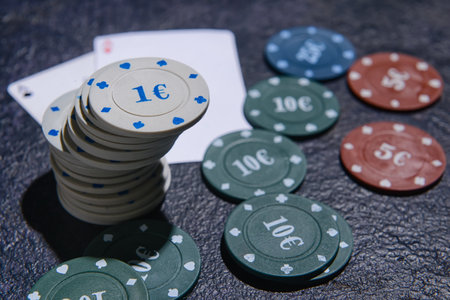 Poker chips and cards on dark background