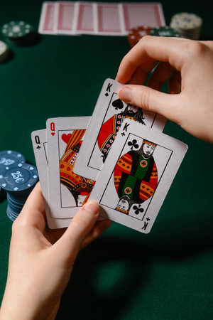 Woman playing poker on dark backgroundの写真素材