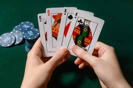 Woman playing poker on dark background