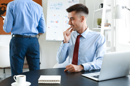 Man looking at butt of his male colleague in office. concept of harassmentの写真素材