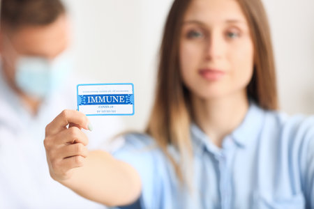 Young woman with International Certificate of Vaccination in clinicの写真素材