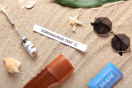 Immune card, covid-19 test result and vaccine on beachの写真素材