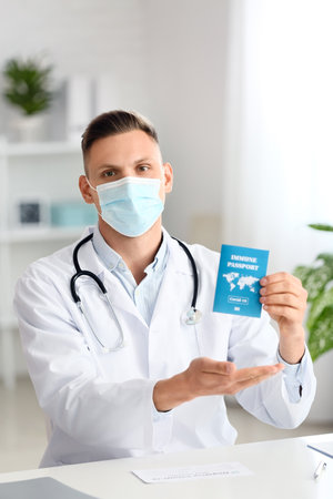 Male doctor with immune passport in clinicの写真素材