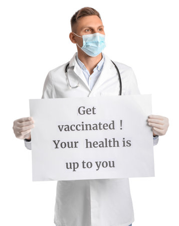 Male doctor holding poster with text GET VACCINATED. YOUR HEALTH IS UP TO YOU on white backgroundの写真素材