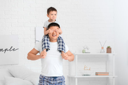 Morning of happy father and his little son in the bedroomの写真素材