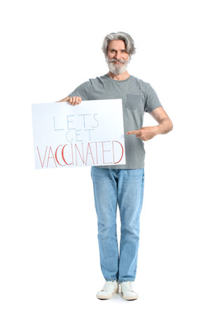 Senior man holding poster with text LET'S GET VACCINATED on white backgroundの写真素材