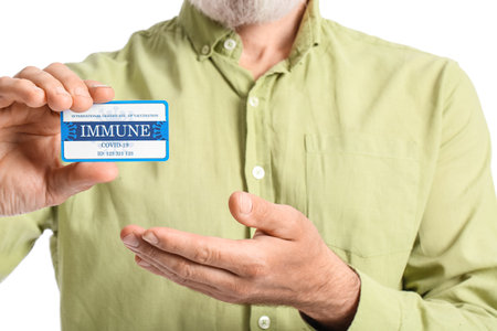 Senior man with International Certificate of Vaccination on white background, closeup