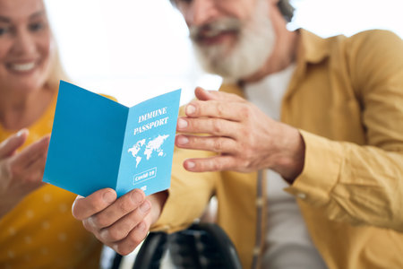 Senior tourists with immune passport at the airport
