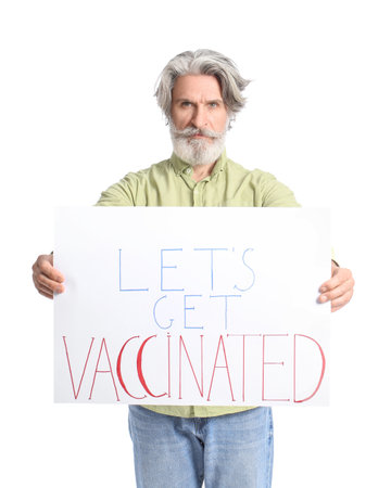 Senior man holding poster with text LET'S GET VACCINATED on white backgroundの写真素材