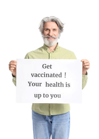 Senior man holding poster with text GET VACCINATED. YOUR HEALTH IS UP TO YOU on white backgroundの写真素材