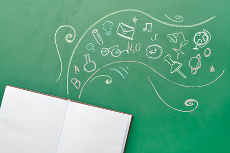 Open book and drawings on color backgroundの写真素材