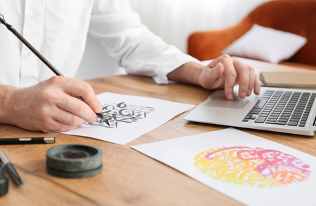 Male Arab calligraphist working in office, closeupの写真素材