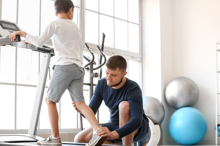 Physiotherapist working with boy in rehabilitation centerの写真素材