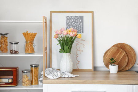 Bouquet of beautiful tulip flowers on counter in kitchen