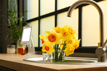 Jug with beautiful daffodils in the kitchenの写真素材