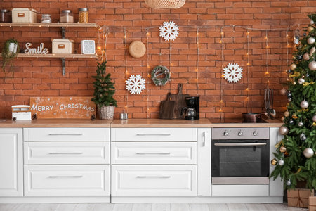 Interior of kitchen with Christmas trees, glowing lights and countersの写真素材