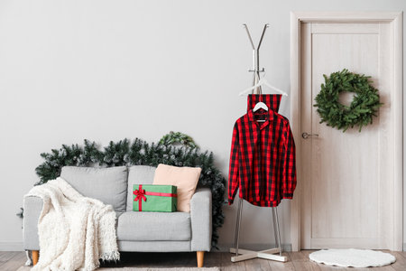 Interior of living room with pajamas, Christmas wreath and sofaの写真素材