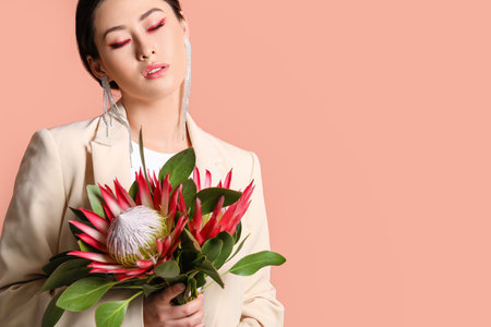 Beautiful young woman with protea flowers on color backgroundの写真素材
