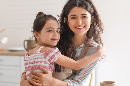 Little girl with her mother at homeの写真素材