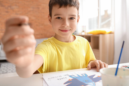 little boy painting at homeの写真素材