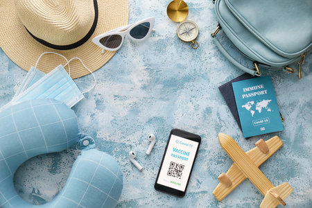 Travel supplies and electronic immune passport on color backgroundの写真素材