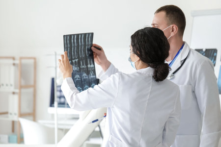 Doctors studying x-ray scan in clinicの写真素材