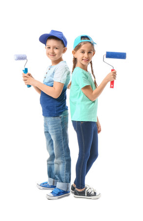 Little children with paint rollers on white backgroundの写真素材