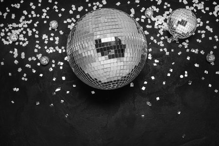 Disco balls with confetti on black backgroundの写真素材
