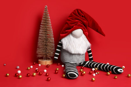 Christmas gnome toy and decor on red backgroundの写真素材