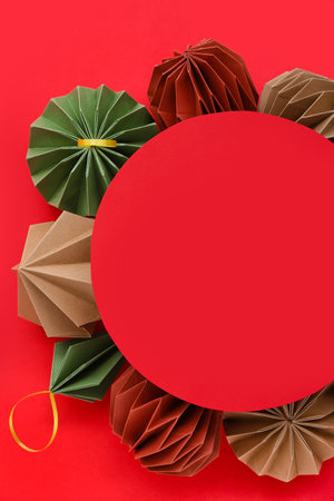 Blank card with paper Christmas balls on red backgroundの写真素材