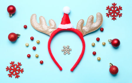 Composition with Christmas reindeer horns and beautiful decorations on color backgroundの写真素材