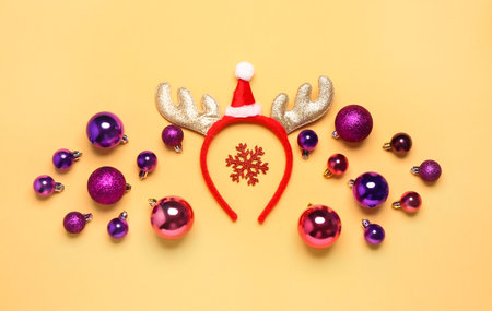 Composition with funny Christmas reindeer horns and beautiful balls on color backgroundの写真素材