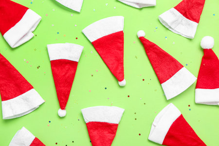 Composition with Santa hats on green backgroundの写真素材