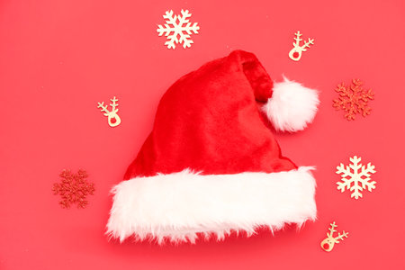 Santa hat and Christmas decorations on red backgroundの写真素材