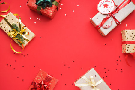 Frame made of Christmas gifts and stars on red background