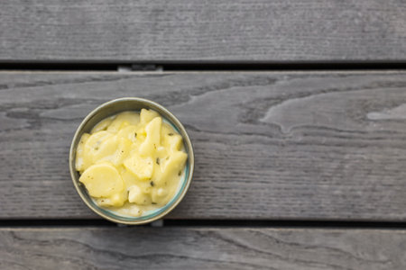 Bowl with creamy potato salad on gray wooden backgroundの写真素材