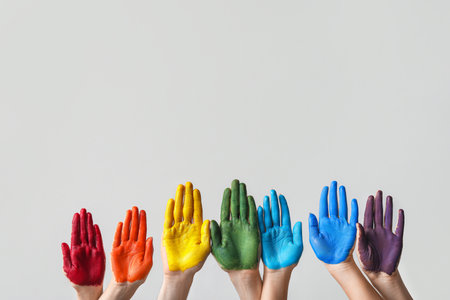 Hands with painted palms on gray background. LGBT concept