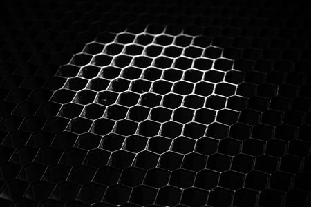 Black grille with backlight as background, closeupの写真素材